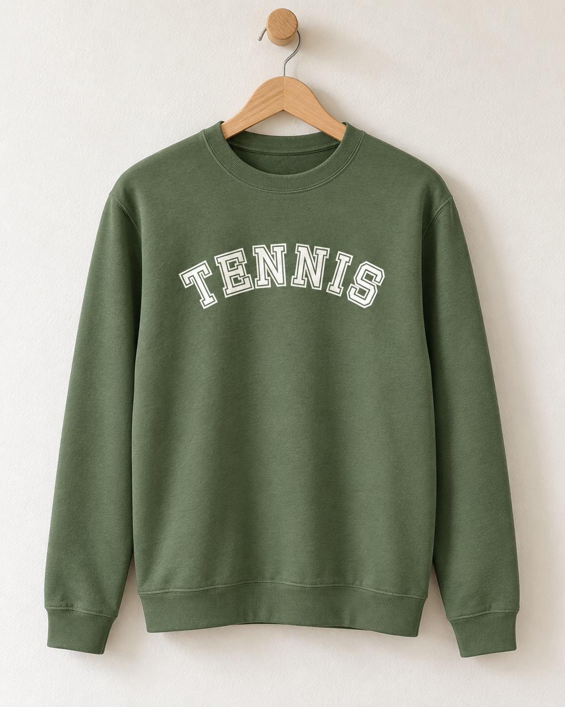 Earthy green unisex tennis sweatshirt hanging on a wooden hanger with white collegiate block lettering across the chest.