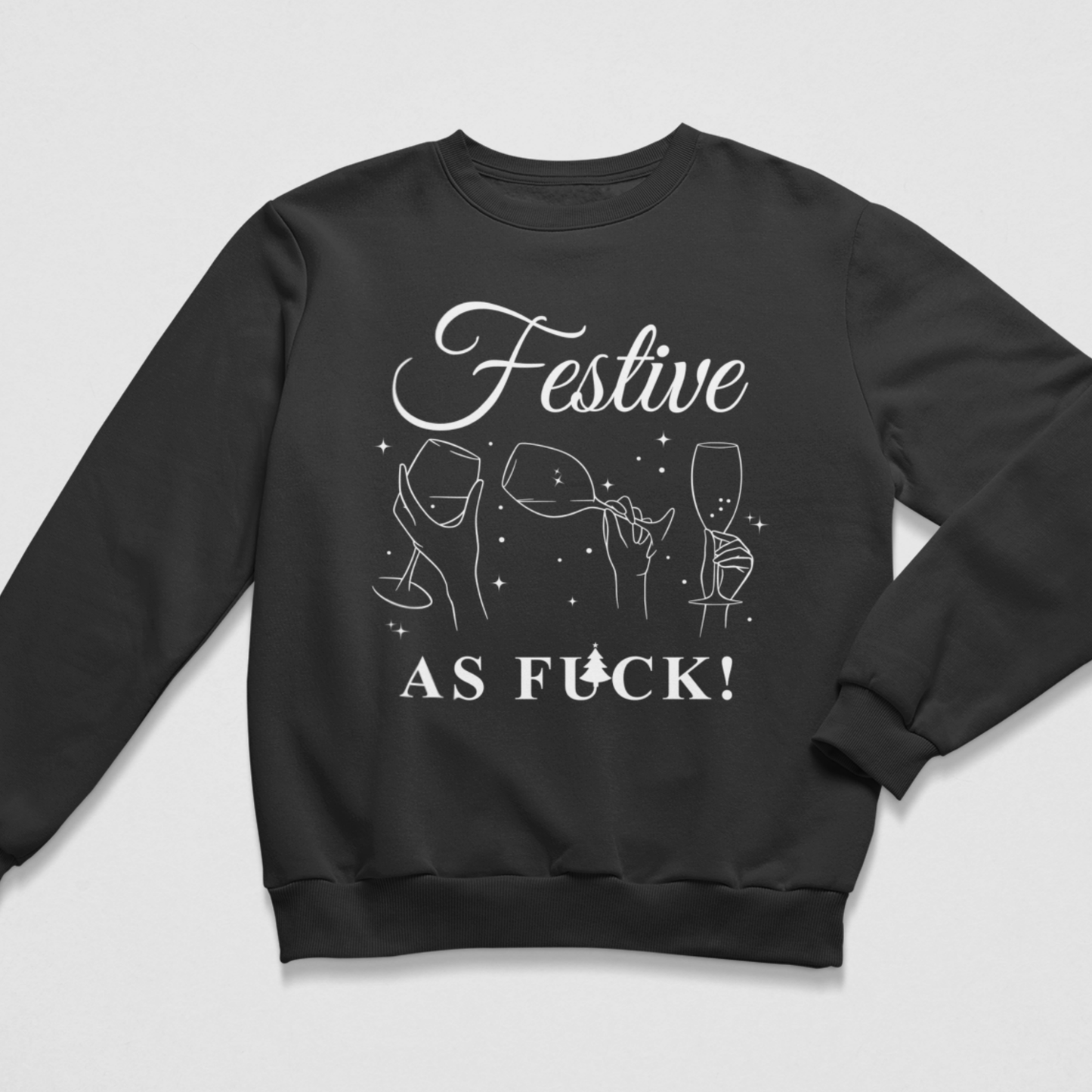 Flat lay of a black Christmas jumper featuring white line-art graphics of hands holding wine and champagne glasses with the text Festive As Fuck.