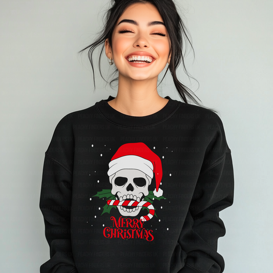 Woman wearing a black organic cotton Christmas sweatshirt featuring a skull in a Santa hat biting a candy cane with “Merry Christmas” gothic text