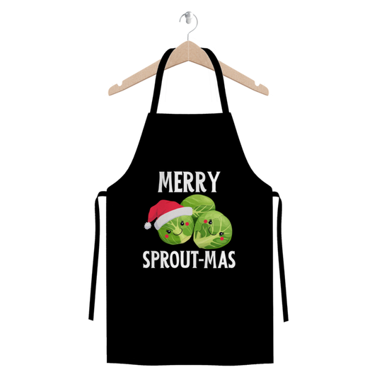 Black Christmas apron on a hanger with cute Brussels sprout characters and the slogan “Merry Sprout-mas” printed on the front.