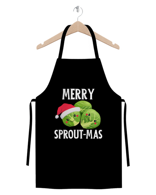 Black Christmas apron on a hanger with cute Brussels sprout characters and the slogan “Merry Sprout-mas” printed on the front.