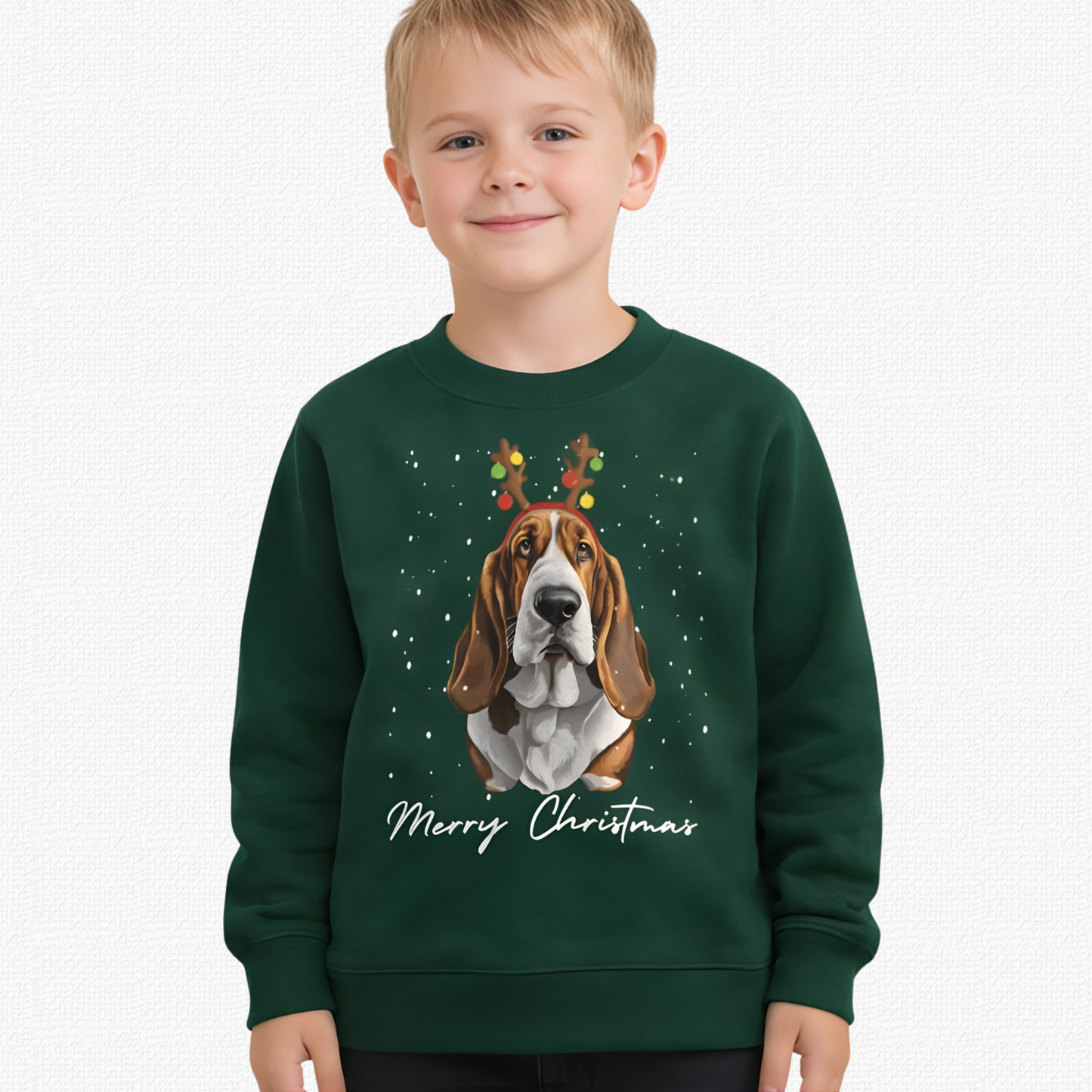 Child wearing a green Christmas-themed sweatshirt with a dog illustration and 'Merry Christmas' text.