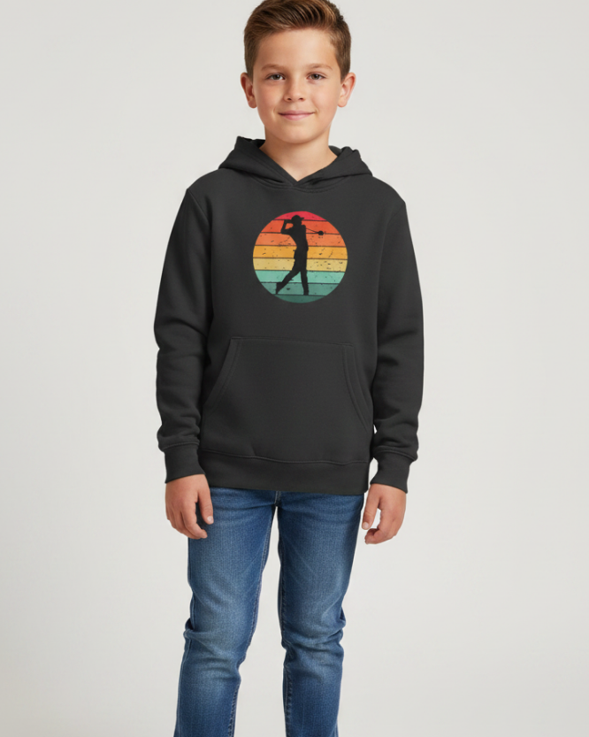 Boy wearing black retro golf pullover hoodie with golfer sunset design hands in pocket kids and teen hoodie studio image