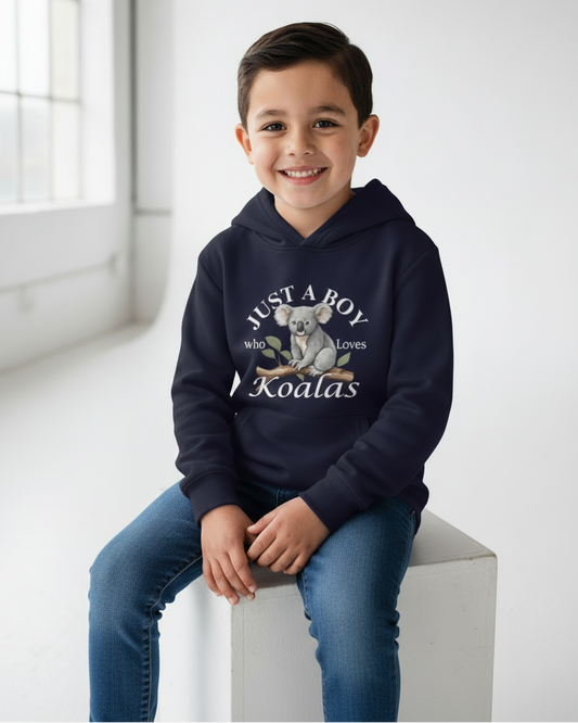 Smiling boy sitting in studio wearing navy koala print hoodie, soft fleece boys hoodie with kangaroo pocket.