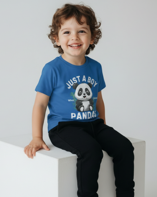 Young boy sitting wearing a royal blue t-shirt with a "Just a Boy who loves Pandas" design and text, studio setting.