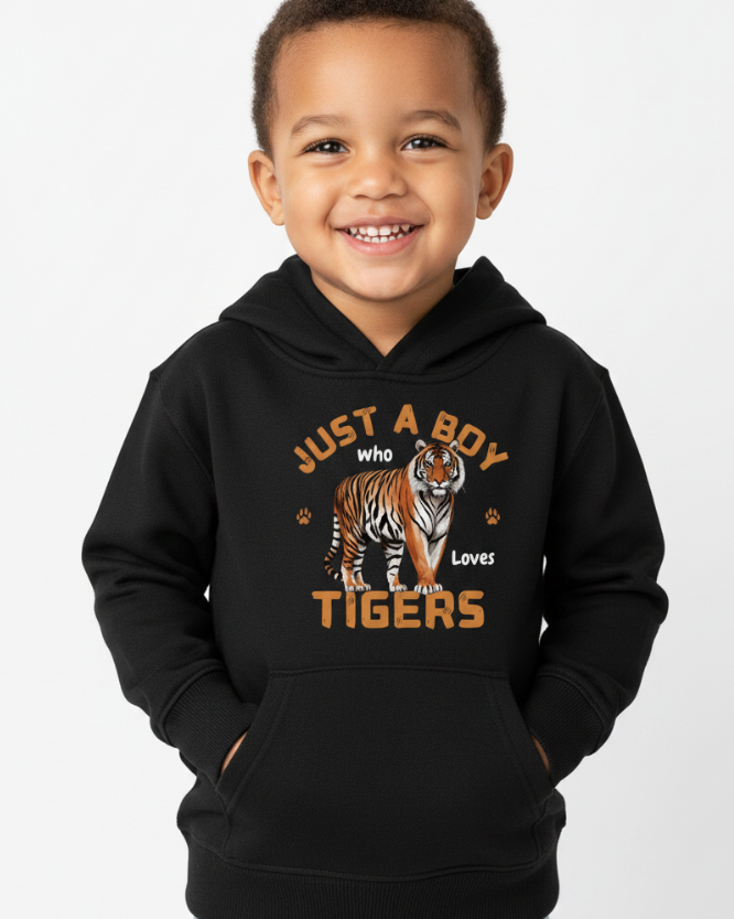 Young boy smiling wearing black “Just a Boy Who Loves Tigers” hoodie in studio setting