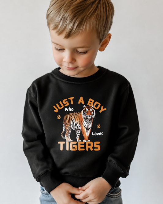 Little boy wearing a black sweatshirt featuring a bold tiger graphic and the phrase "Just a Boy Who Loves Tigers" design with foot prints and claw marks.