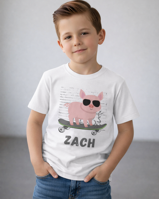 Young boy wearing white personalised skateboarding pig t-shirt with custom name Zach, relaxed studio pose, soft natural lighting