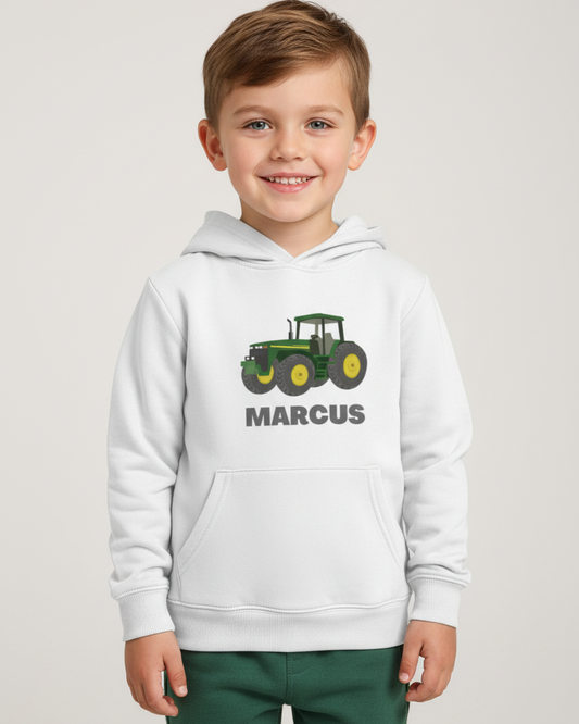 Boy wearing white personalised tractor hoodie with name printed underneath, studio photo with clear front graphic.