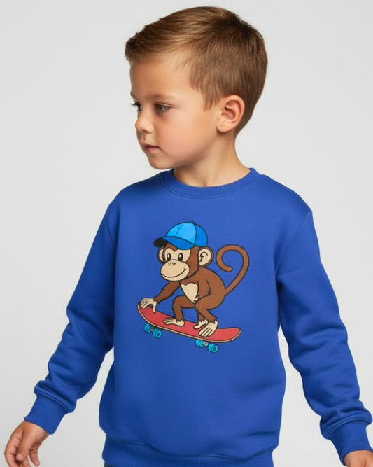 Boy wearing royal blue kids skateboard monkey sweatshirt, side view studio photo, soft cotton children's pullover.
