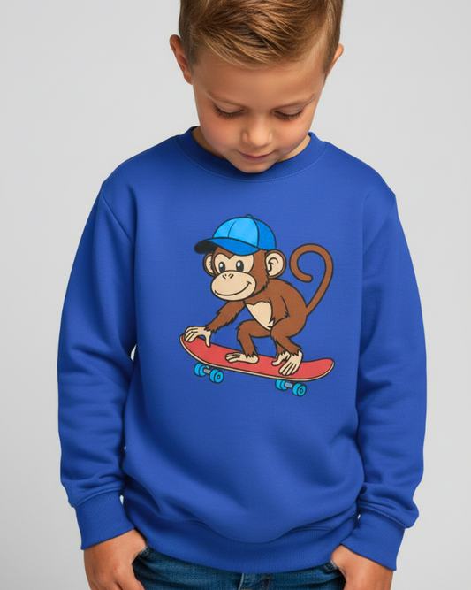 Child modelling royal blue skateboard monkey sweatshirt, front view studio image, comfortable kids crewneck jumper.