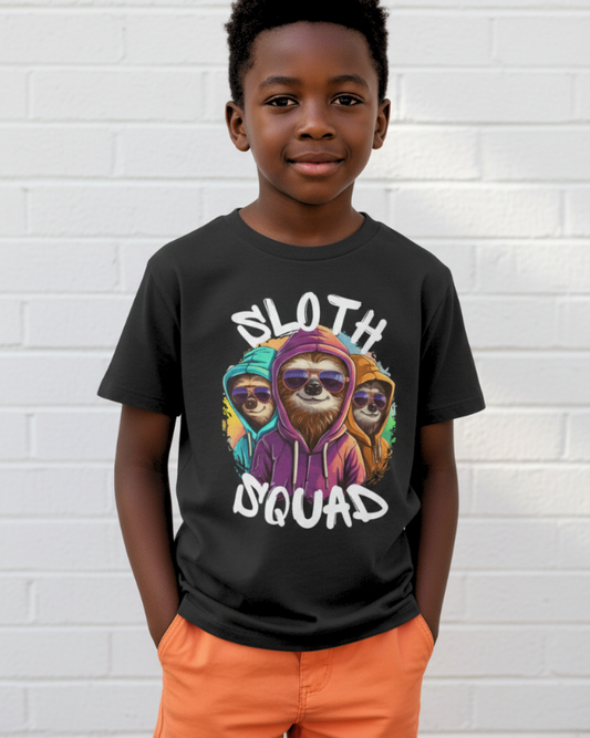 Boy modelling black Sloth Squad kids t-shirt with colourful sloth graphic and white text, standing against white brick wall.