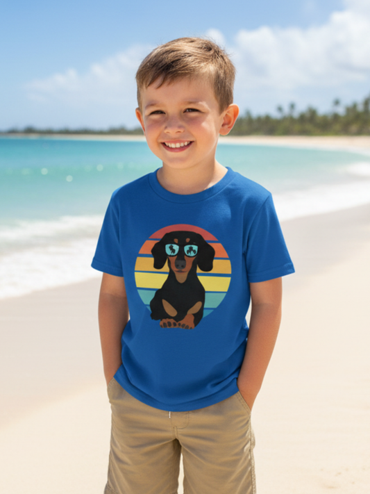 Smiling young boy wearing royal blue dachshund sunglasses t-shirt on a sunny beach