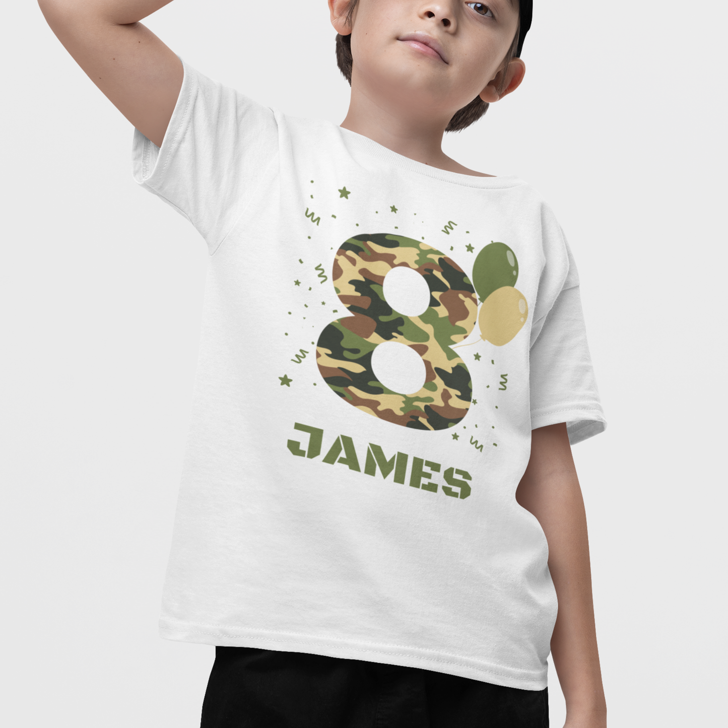 Boy wearing a personalised camouflage number 8 birthday t-shirt with name Jamie, white kids birthday tee with green camo design