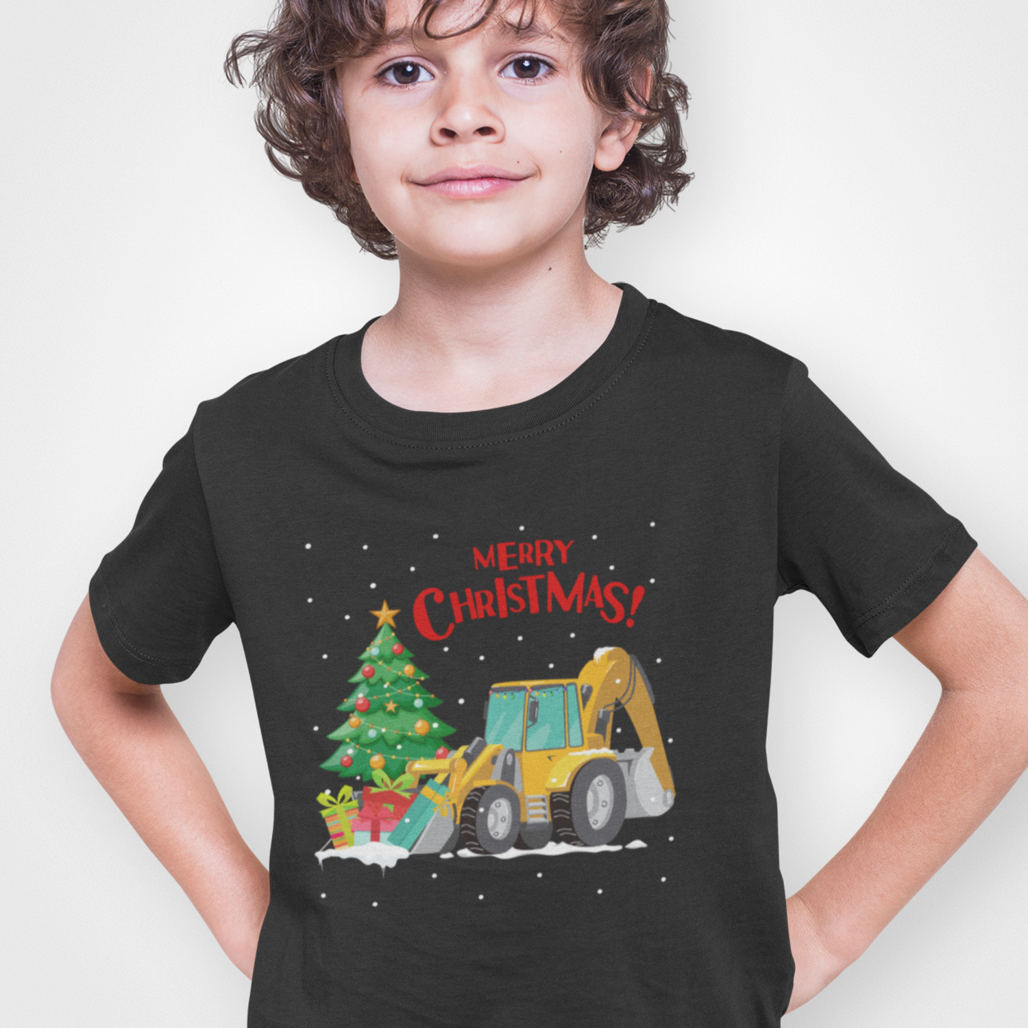 Child wearing a black t-shirt with a Christmas-themed design featuring a bulldozer and tree.