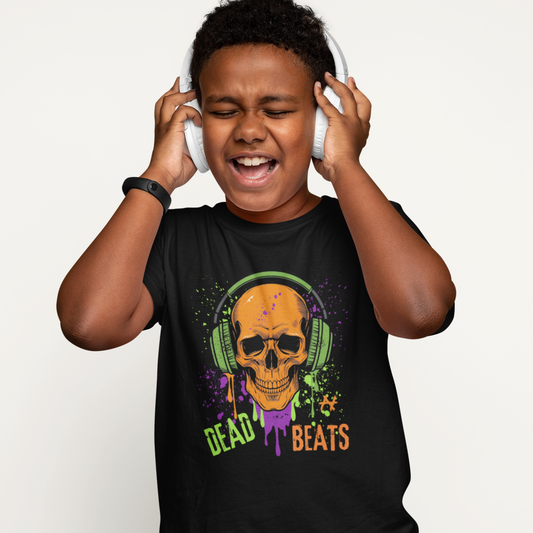 Boy wearing black kids t-shirt featuring orange skull with green headphones and colourful paint splashes reading ‘Dead Beats’