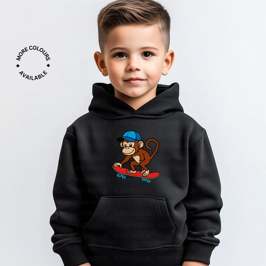 boy wearing black pullover hoodie with skateboarding monkey graphic
