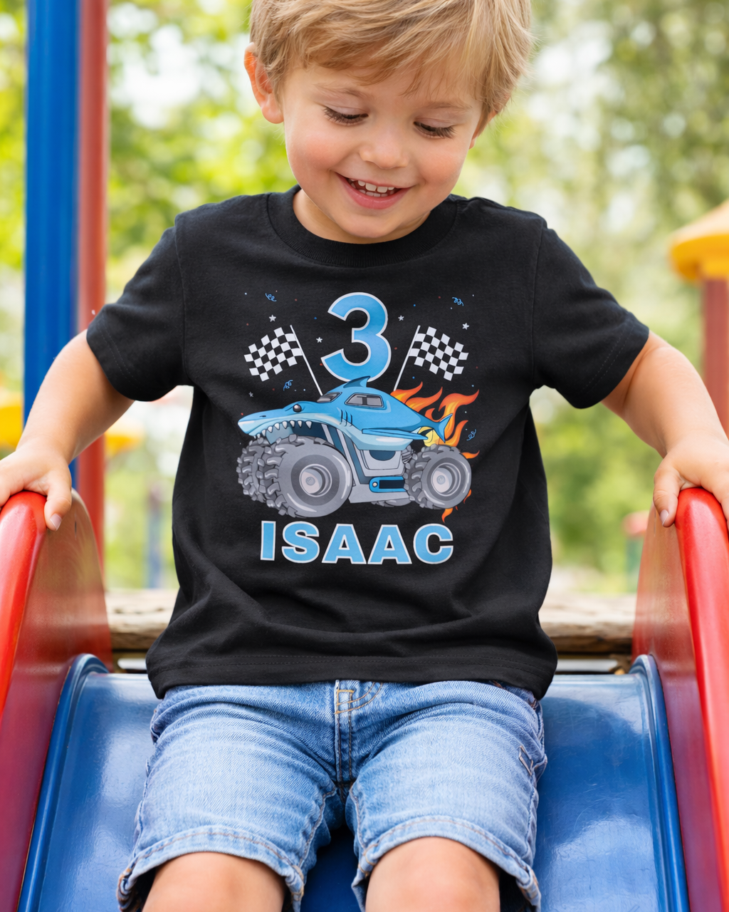 3rd birthday personalised monster truck t-shirt with name Isaac, black boys birthday shirt worn outdoors on playground slide