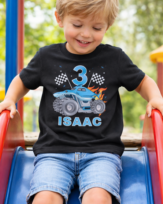 3rd birthday personalised monster truck t-shirt with name Isaac, black boys birthday shirt worn outdoors on playground slide