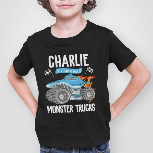 A child wearing a black t-shirt with a graphic of a blue monster truck and the name 'Charlie' printed below it.