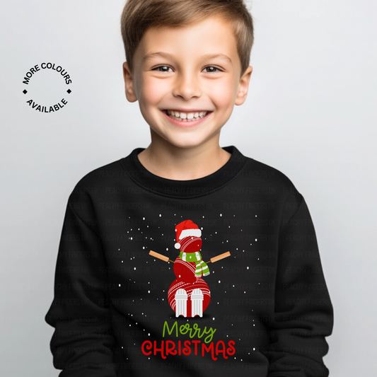Child wearing a black Christmas-themed sweatshirt with a snowman made of cricket balls complete with Santa hat design and 'Merry Christmas' text.