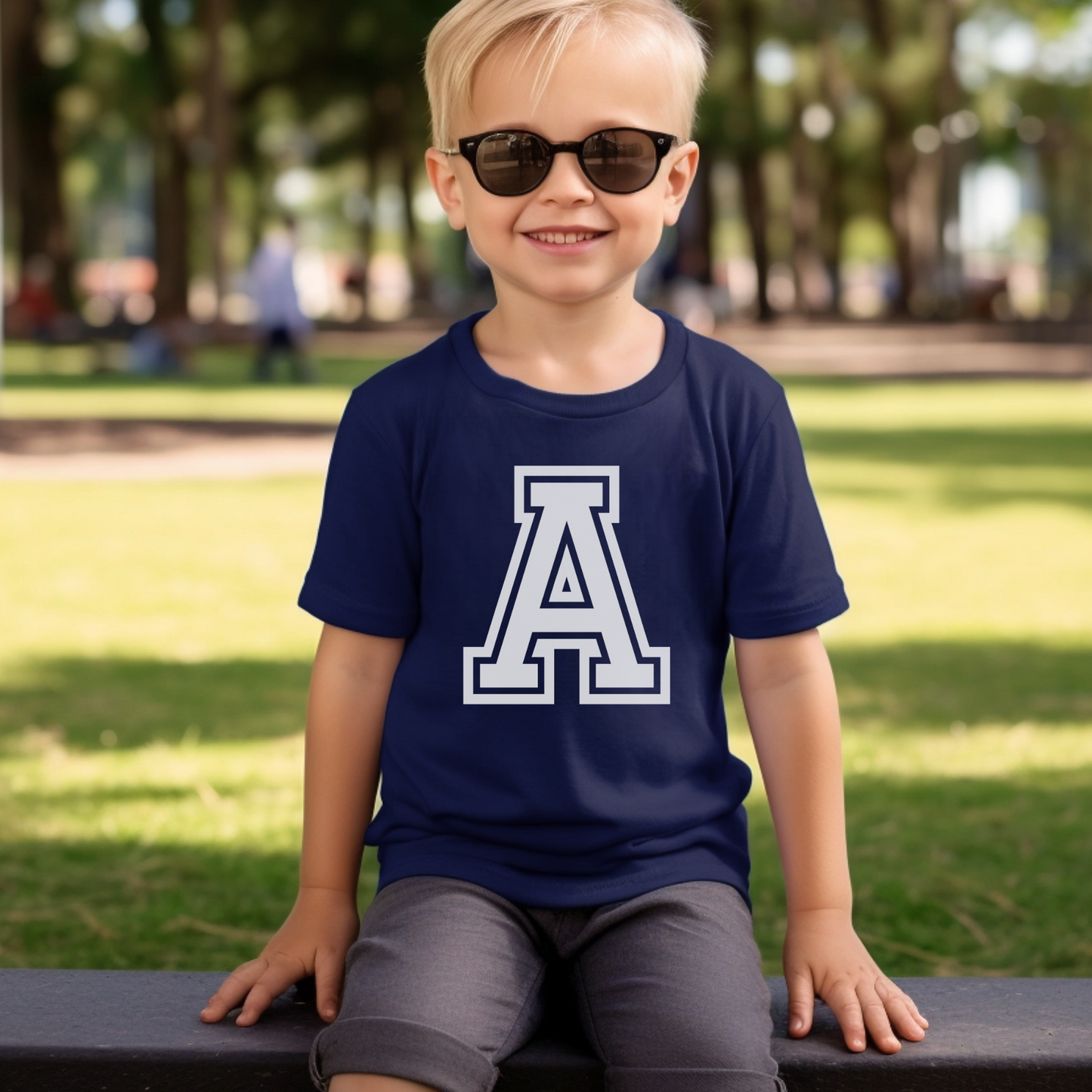 boy wearing a navy blue t-shirt with large printed initial