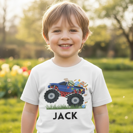 Child wearing a white t-shirt with a colourful easter themed monster truck graphic and the name 'Jack' outdoors.