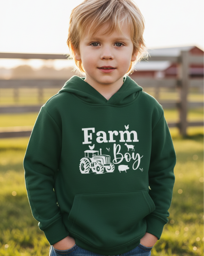 Young boy wearing green hoodie with “Farm Boy” tractor design – kids farm hoodie outfit outdoors
