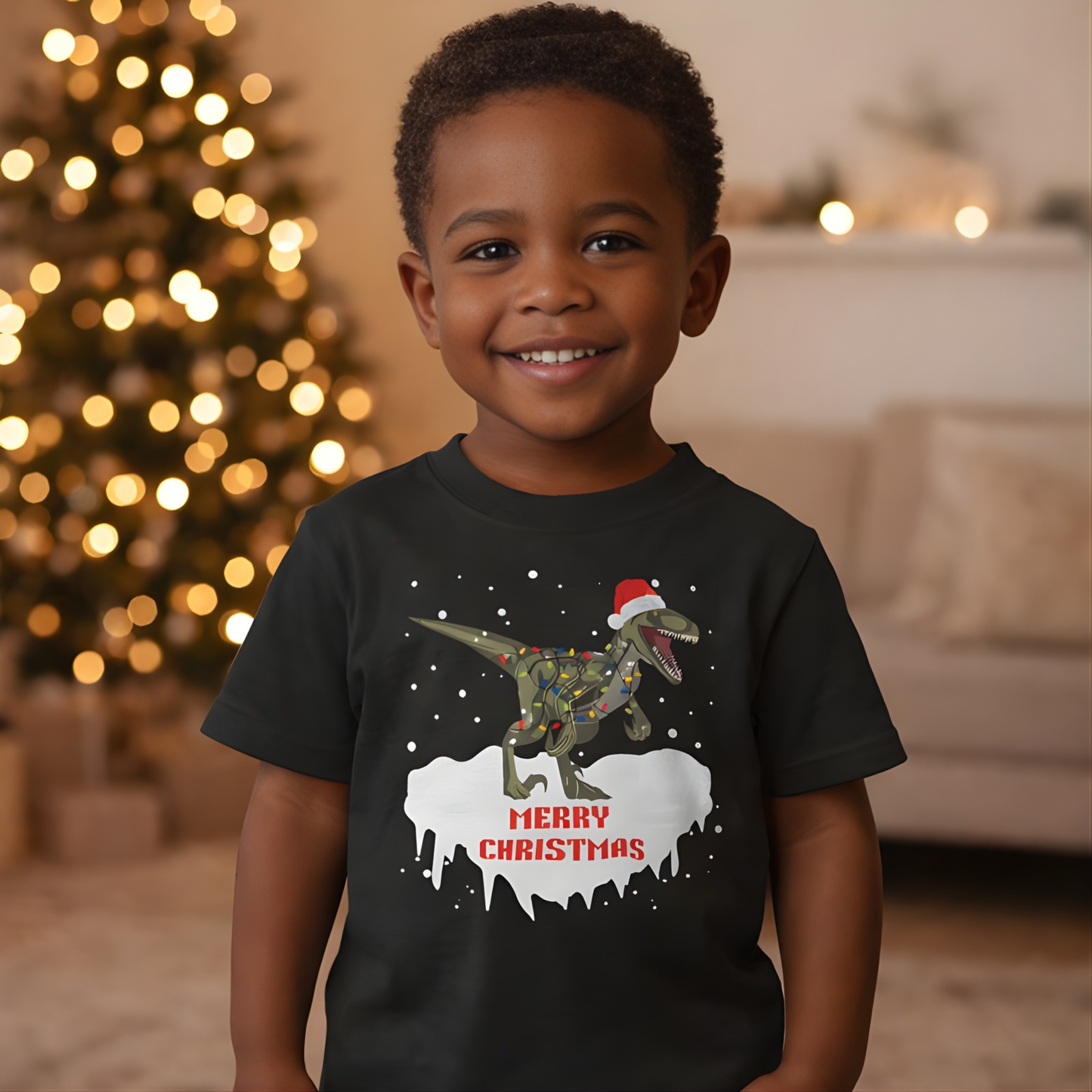 Smiling boy wearing festive dinosaur Merry Christmas t-shirt with Christmas tree lights in background