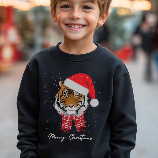 Boy wearing black Christmas sweatshirt with festive tiger in Santa hat and scarf, text reads “Merry Christmas.”
