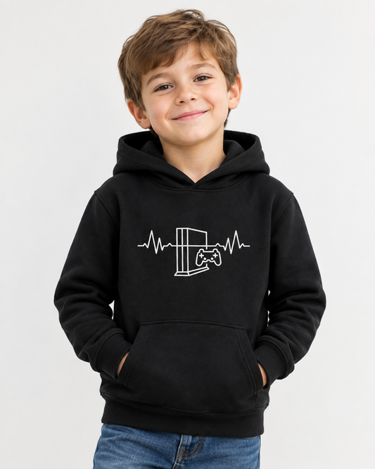 Young boy models black pullover hoodie with a white graphic on the chest depicting a video game console and controller inside an EKG heartbeat line, shown against a light grey background.