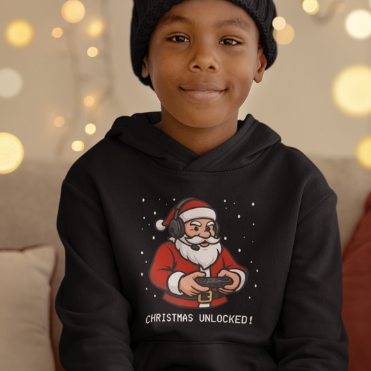 Boy wearing a black kids hoodie with gaming Santa design and "Christmas Unlocked!" text, festive background.