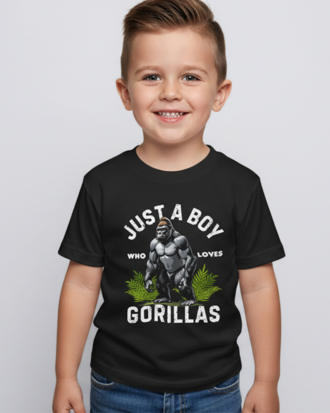 Young boy wearing black "Just a Boy Who Loves Gorillas" kids t-shirt, studio portrait on light grey background, front view showing gorilla graphic clearly