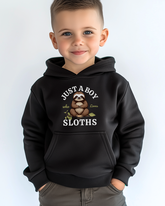 A young boy wearing a black hoodie with the words “Just A Boy Who Loves Sloths” and a cute brown sloth sitting on a leafy branch printed on the front.