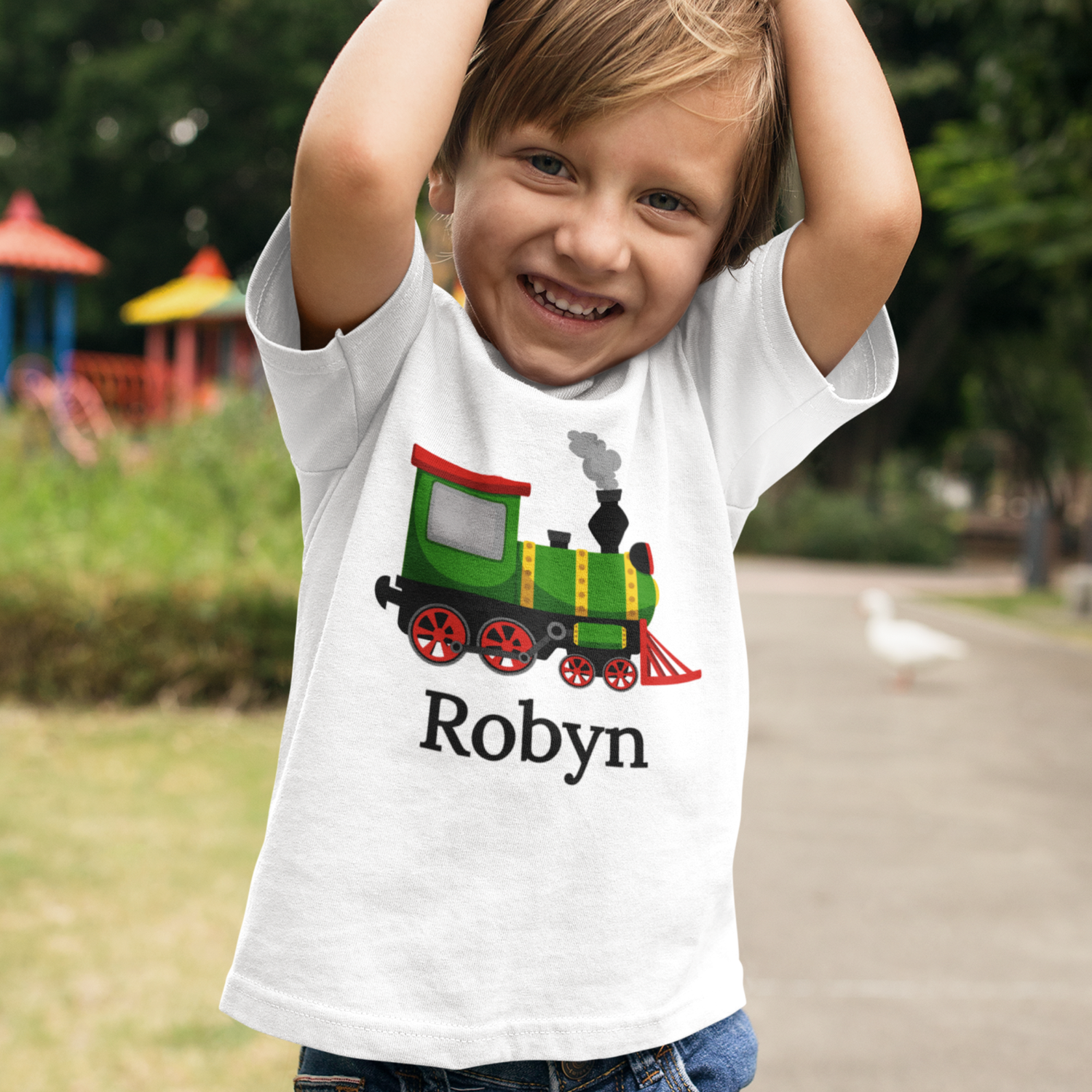 Little boy wearing a personalised steam train t-shirt with his name printed underneath