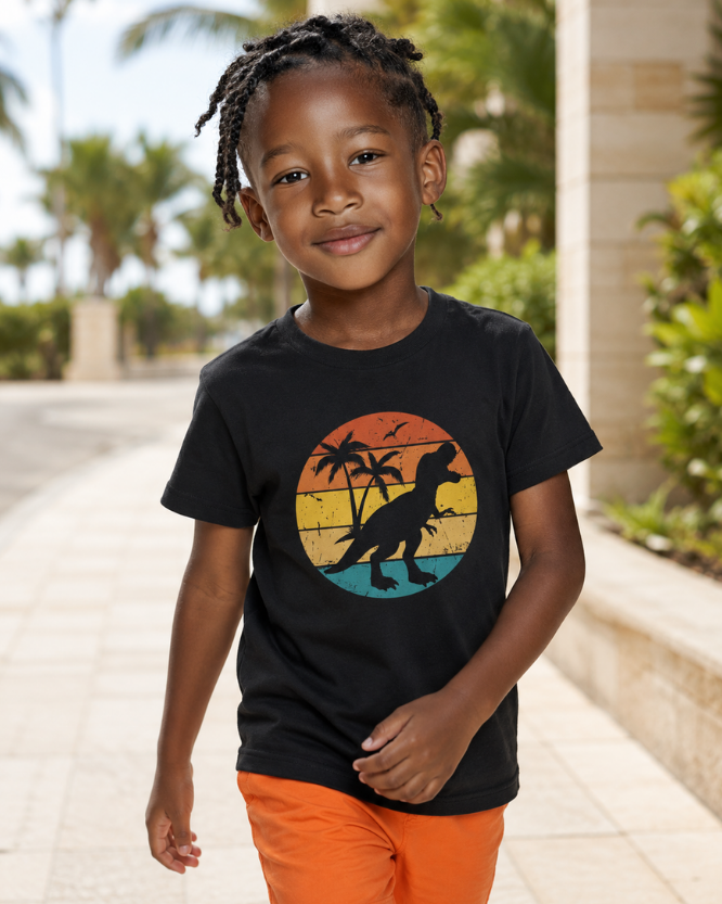 Boy wearing dinosaur t-shirt with colourful sunset palm tree graphic in black, paired with orange summer shorts