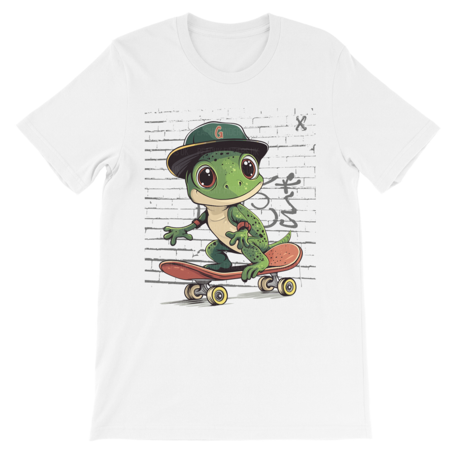 A white t-shirt displays a cartoon graphic of a green gecko wearing a dark green and tan baseball cap with a "G" on it. The gecko is riding a skateboard with yellow wheels. The background of the graphic is a brick wall with grey graffiti.