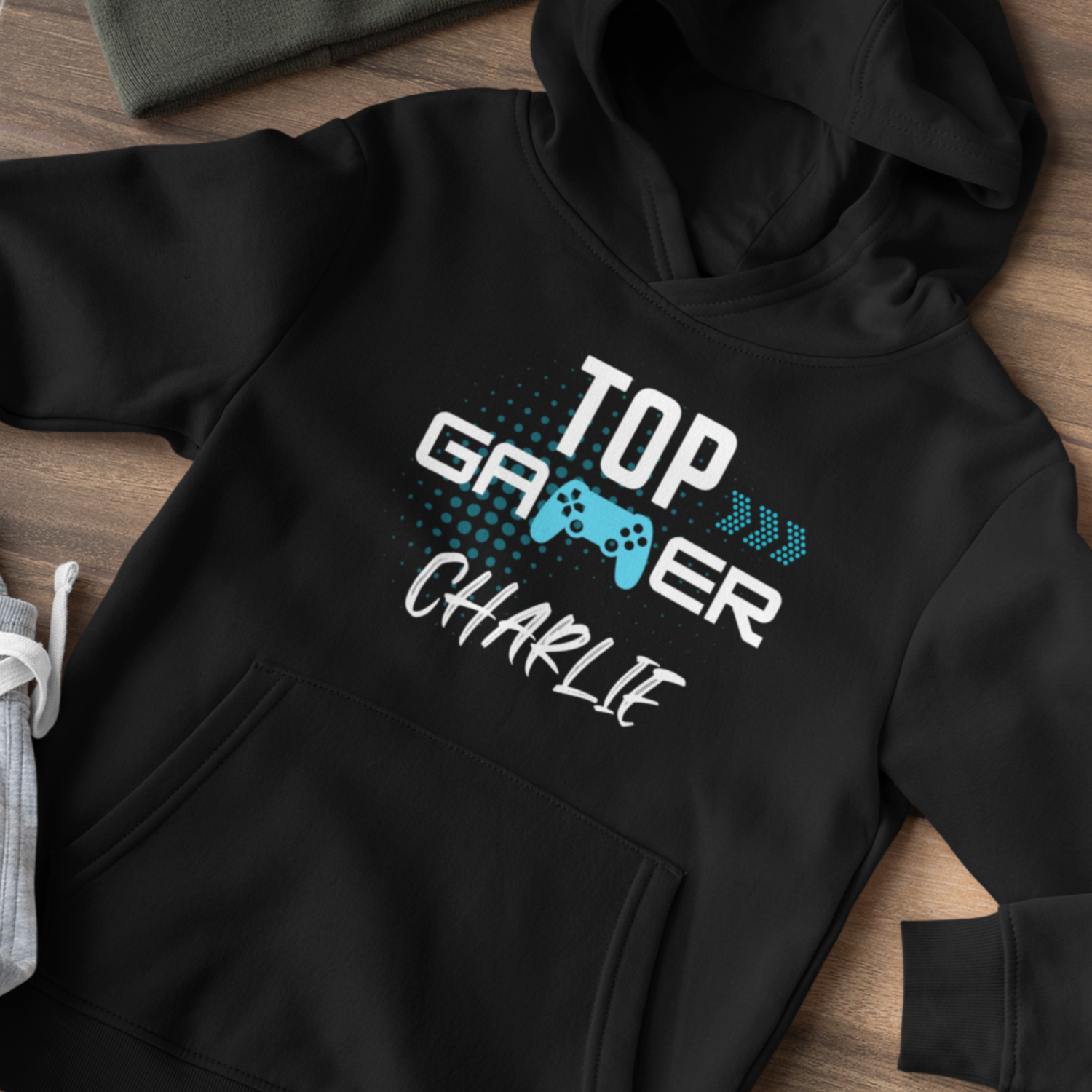 A black hoodie with the printed words "top gamer" and a personalised name in white