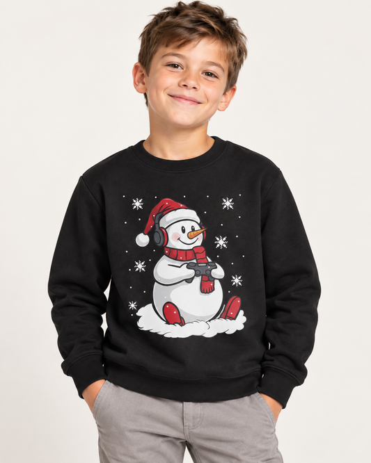8-year-old boy wearing a black gaming snowman Christmas jumper in a bright studio.