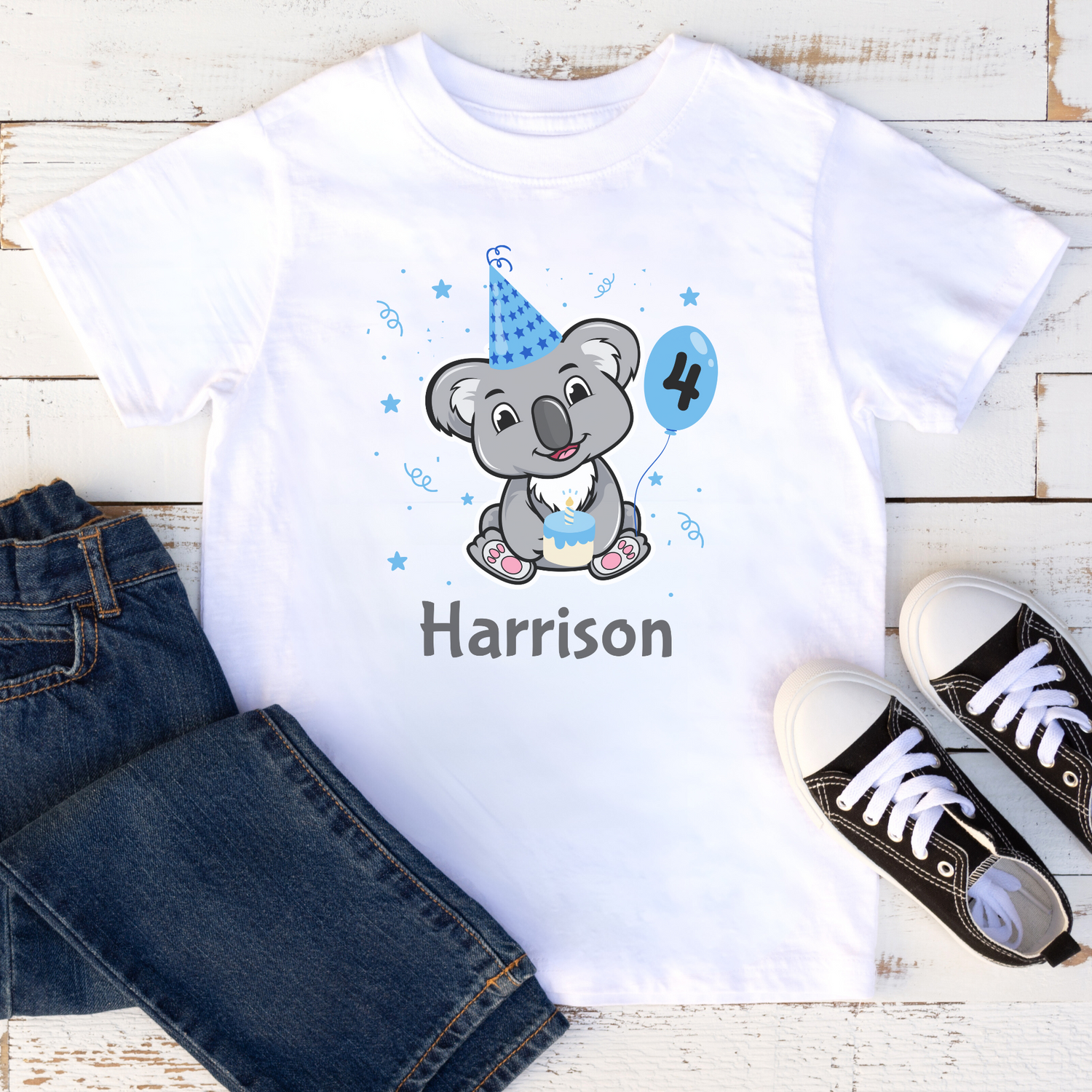 Boys white birthday T-shirt featuring a cute koala in a blue party hat holding a balloon with number four and cake, personalised with the name Harrison.