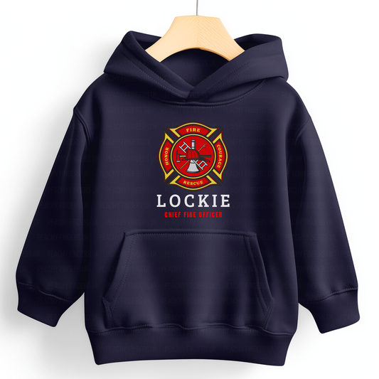 A navy-coloured kid's hoodie with custom name and "Chief Fire Officer" on the front, featuring a fire department emblem with 'FIRE,' 'RESCUE,' 'HONOR,' and 'COURAGE' text.