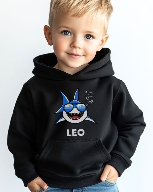 Young boy wearing personalised black pullover hoodie with cartoon shark and custom name