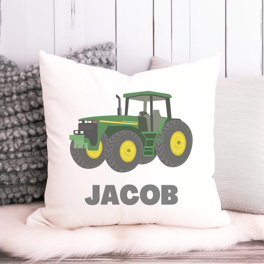 A canvas style cushion cover featuring a green and yellow tractor with the custom name printed below it.