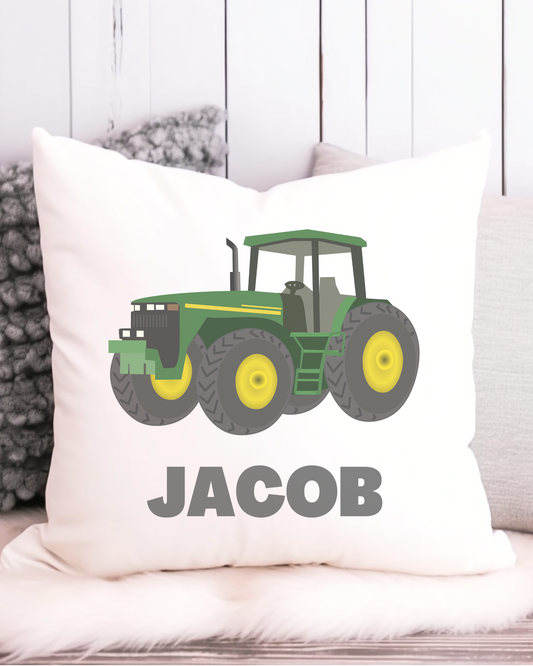 A canvas style cushion cover featuring a green and yellow tractor with the custom name printed below it.