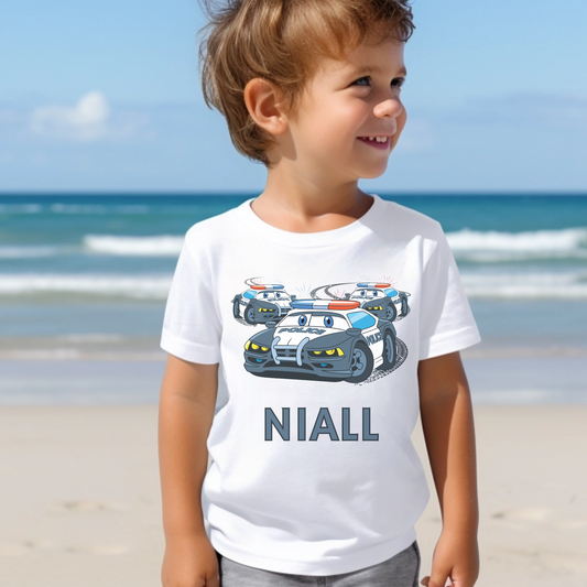 A little boy wearing a white short sleeve t-shirt printed police chase and personalised name