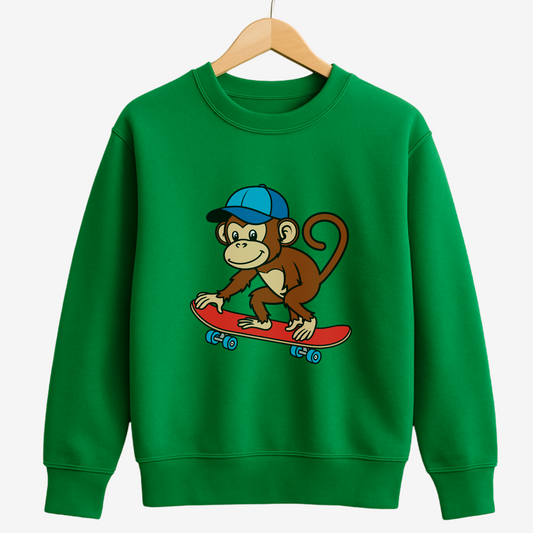 Kids green sweatshirt with a monkey on a skateboard graphic styled on a wooden hanger.