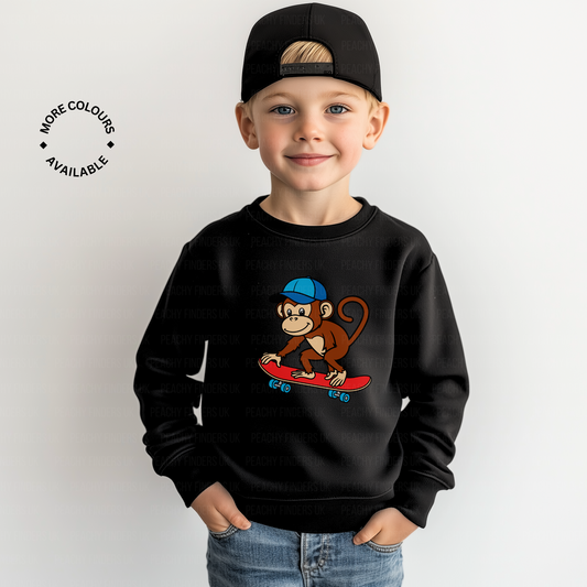 Little boy wearing a black sweatshirt with skateboarding monkey graphic