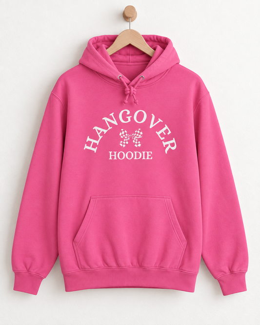 Ladies candy-floss pink adult Hangover Hoodie with white curved lettering and chequered bow design displayed on a wooden hanger.