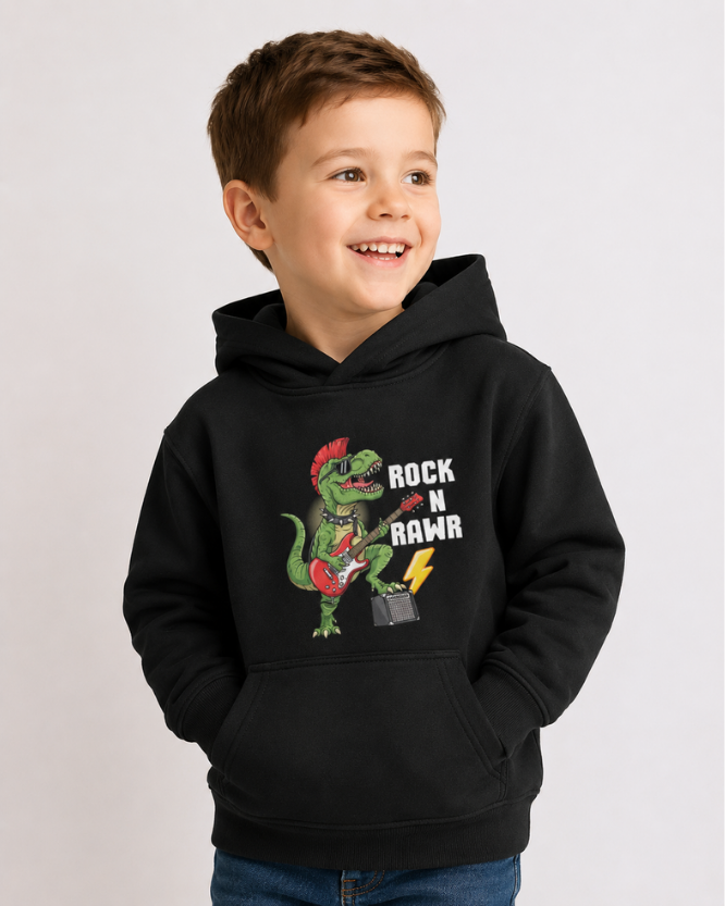 Boy wearing black Rock N Rawr dinosaur guitar kids hoodie in studio mockup with playful T-Rex graphic and jeans
