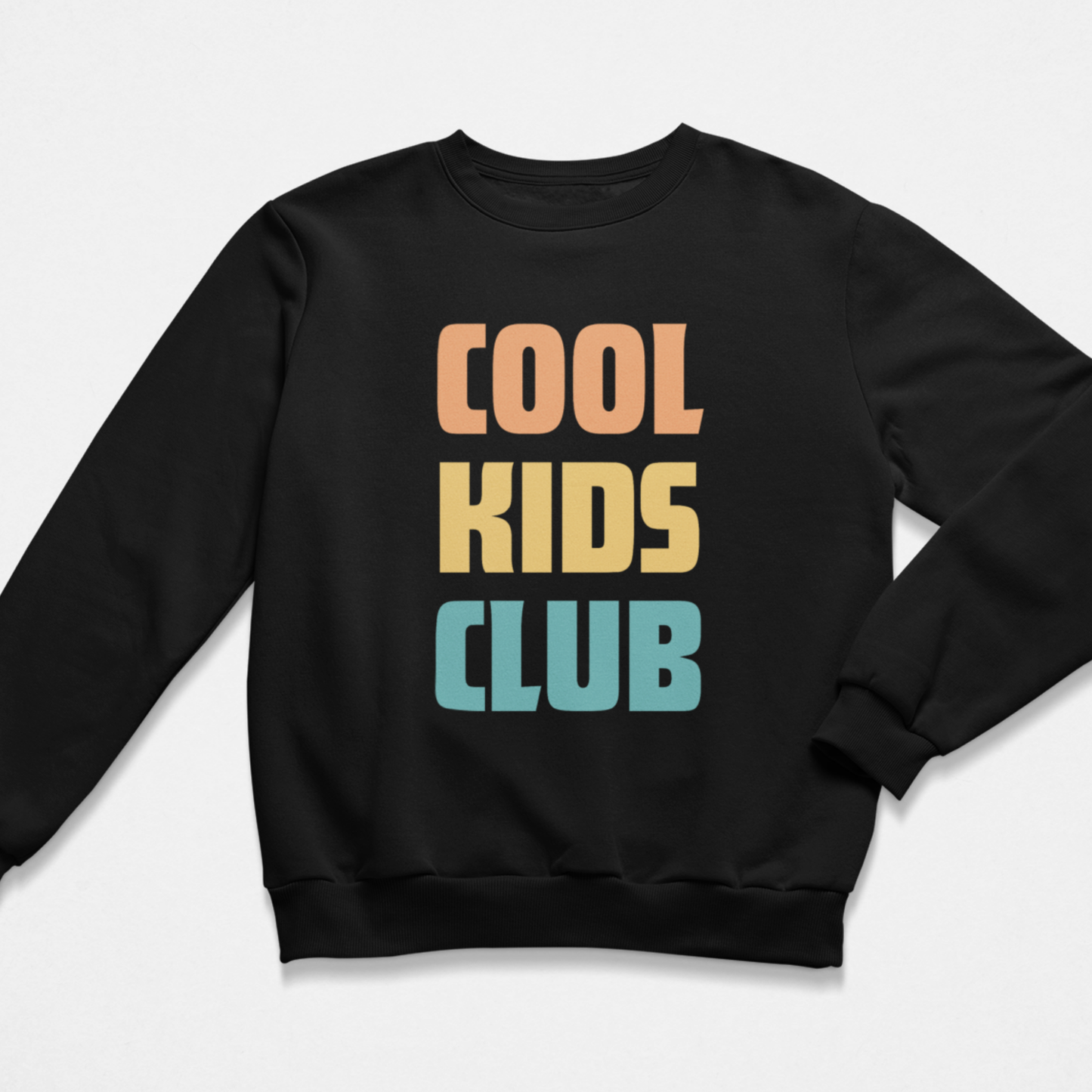 A kids black crewneck sweatshirt with the words 'COOL KIDS CLUB' printed slogan on the front in a retro stacked font, with 'COOL' in peach, 'KIDS' in yellow, and 'CLUB' in light blue, shown on a light grey background.